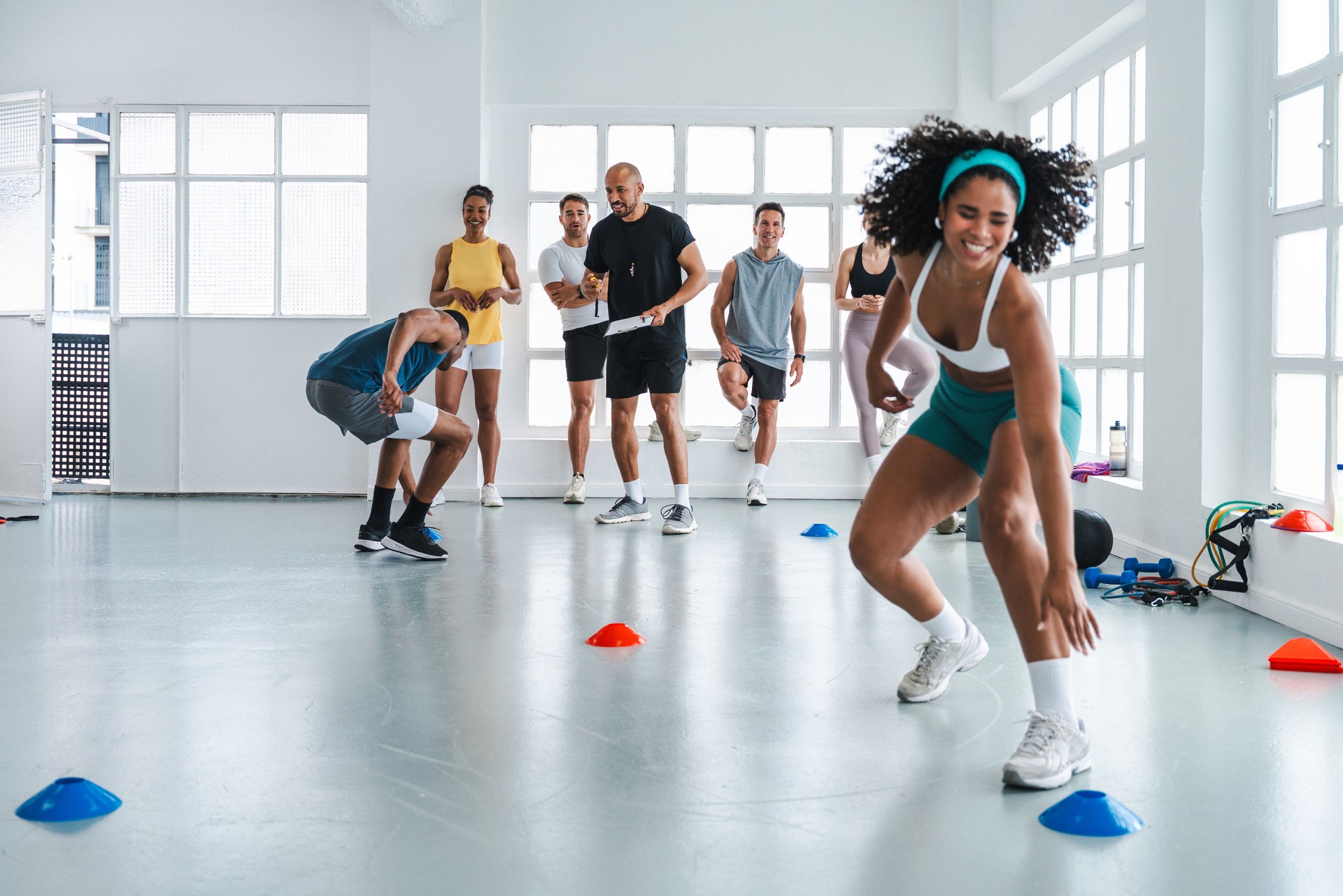 Athletes doing functional training workout with personal trainer